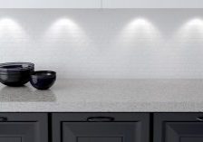 Ceramic kitchenware on the shelf. Marble worktop. White and black kitchen design.